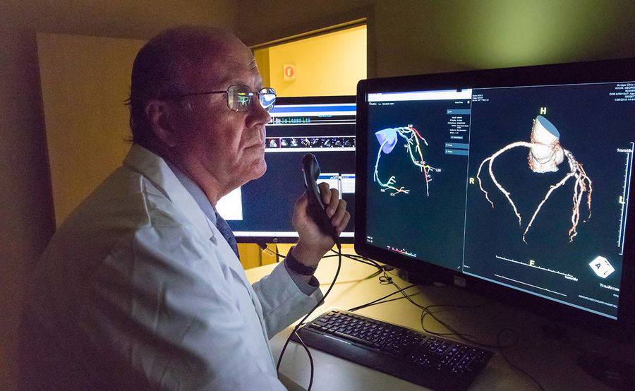 Scripps Clinic cardiologist George Wesbey III, MD, reviews the results of a patient's diagnostic tests for heart disease.