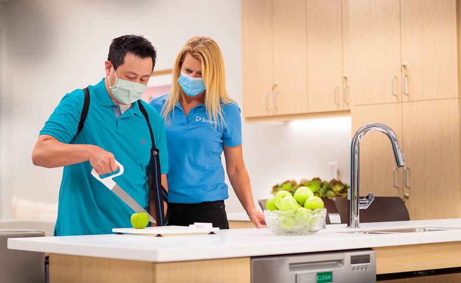 A patient and an occupational therapist during a therapy session.