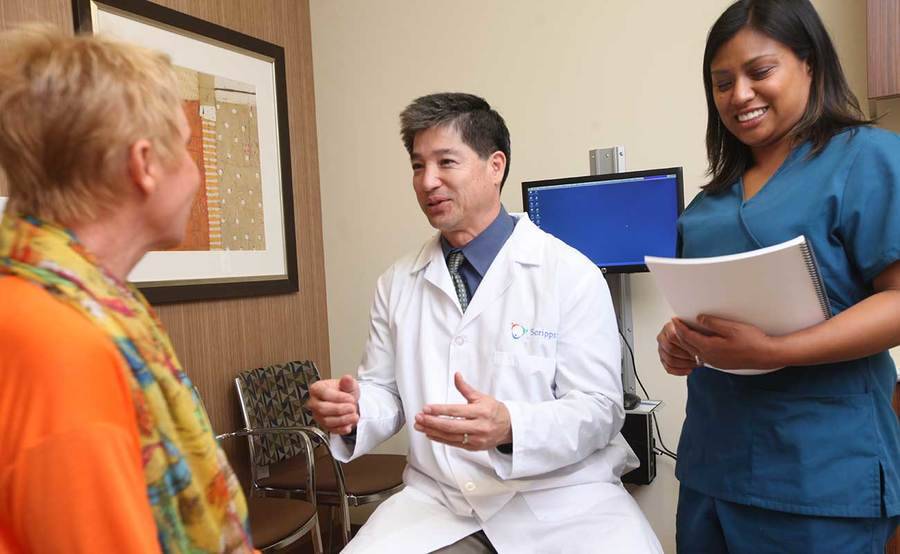 A smiling doctor, nurse and patient represent the importance of skin cancer screening and prevention.