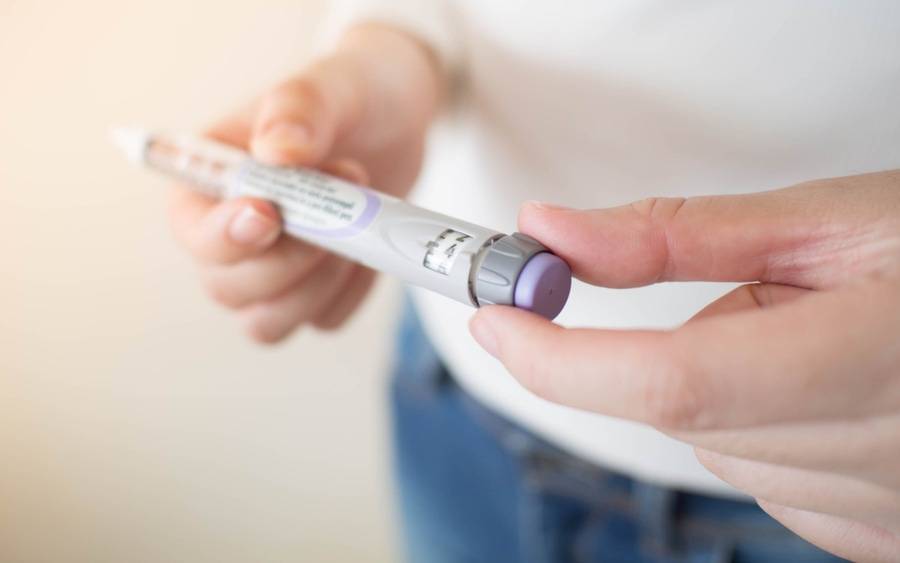A weight management patient examines a weight-loss drug.